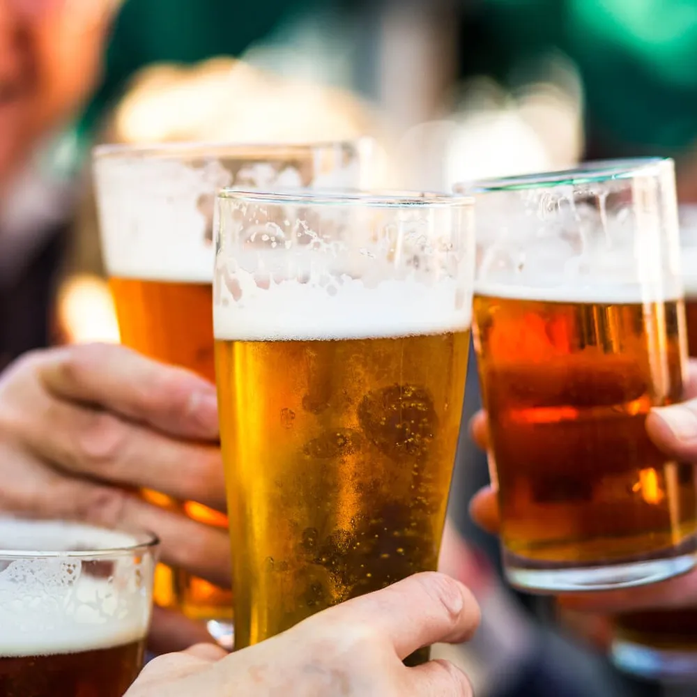 People giving a cheers with their beers