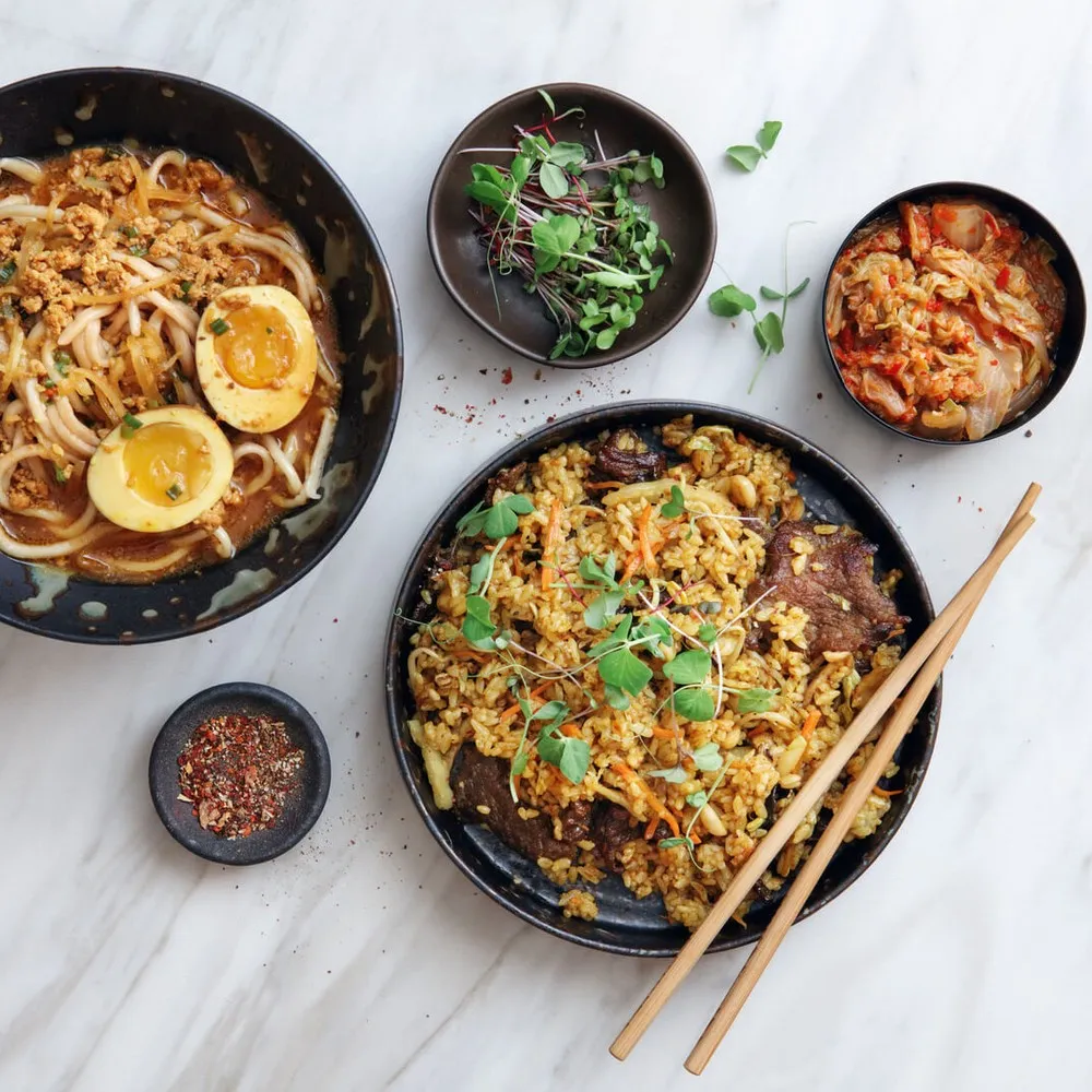 Noodles and rice dishes on table