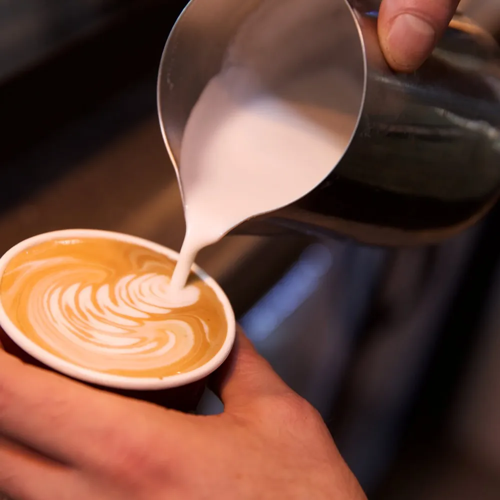Pouring milk into coffee