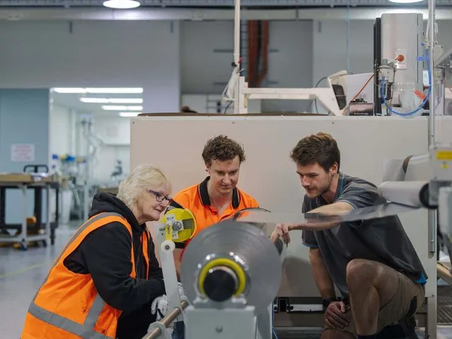 Caliber Design engineers checking machine