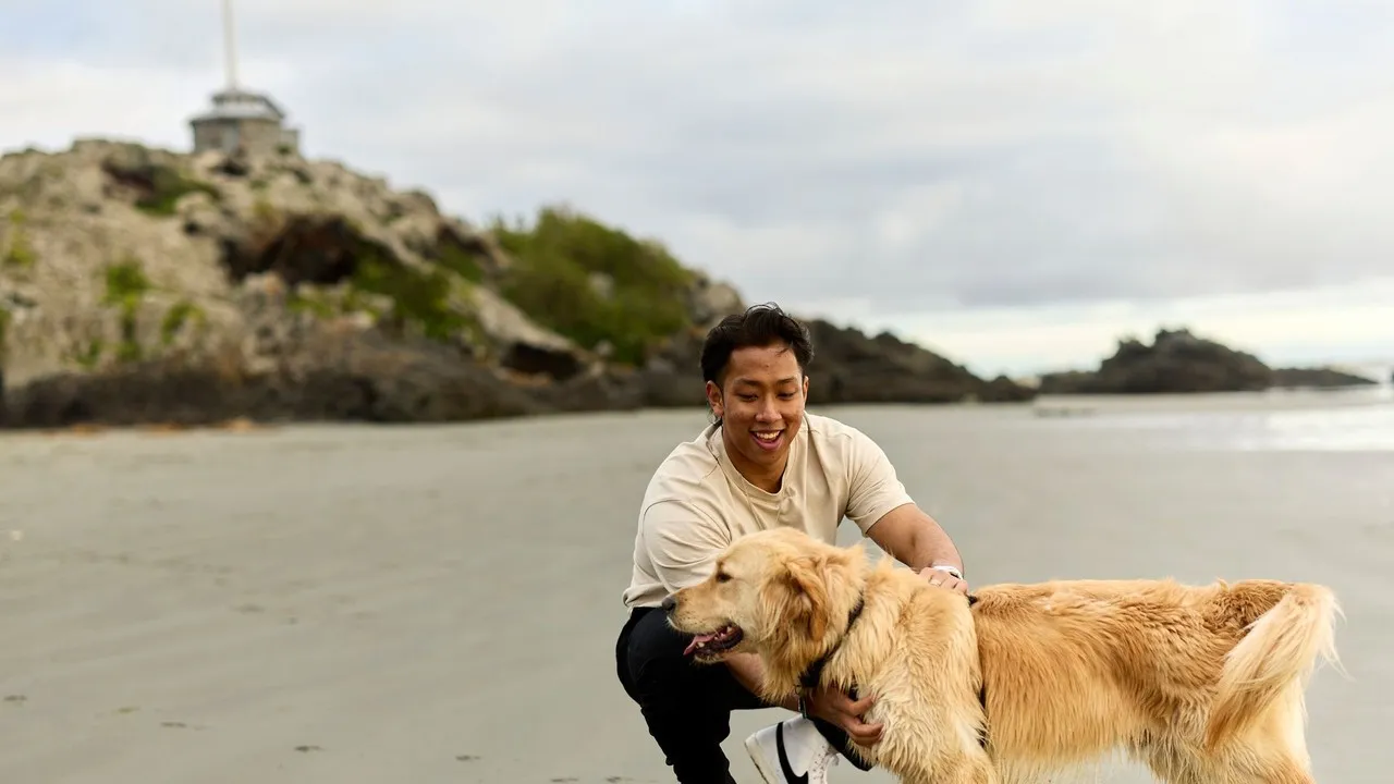 Canterbury University student with his dog on Sumner Beach