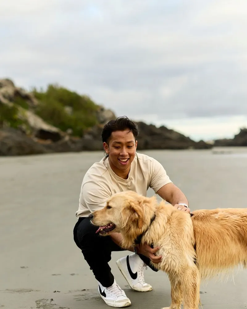 Canterbury University student enjoying spare time in Sumner with his dog