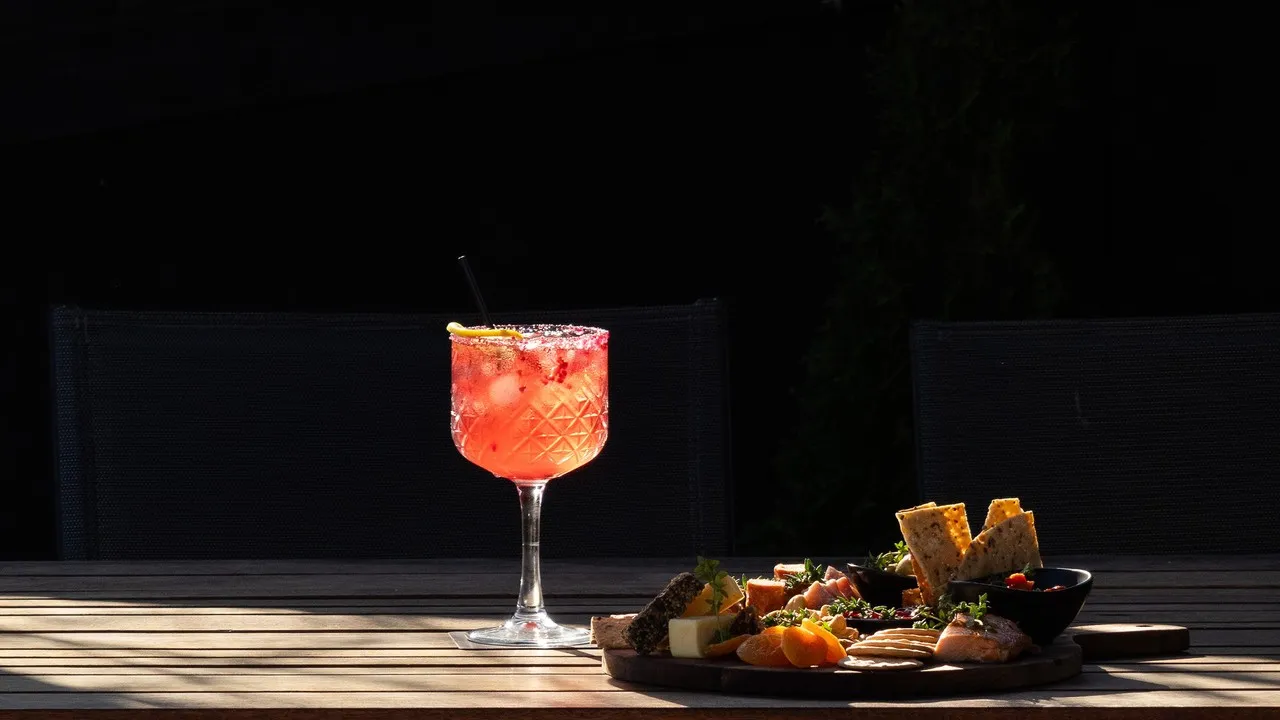A gin cocktail with a grazing platter