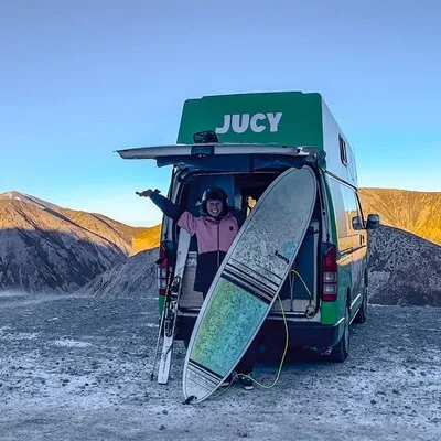 Laura with surf and snow equipment in her Jucy van