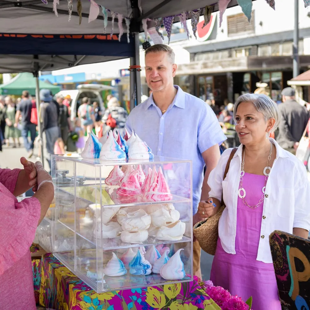 A couple enjoying treats at the Lyttelton Farmers Market.