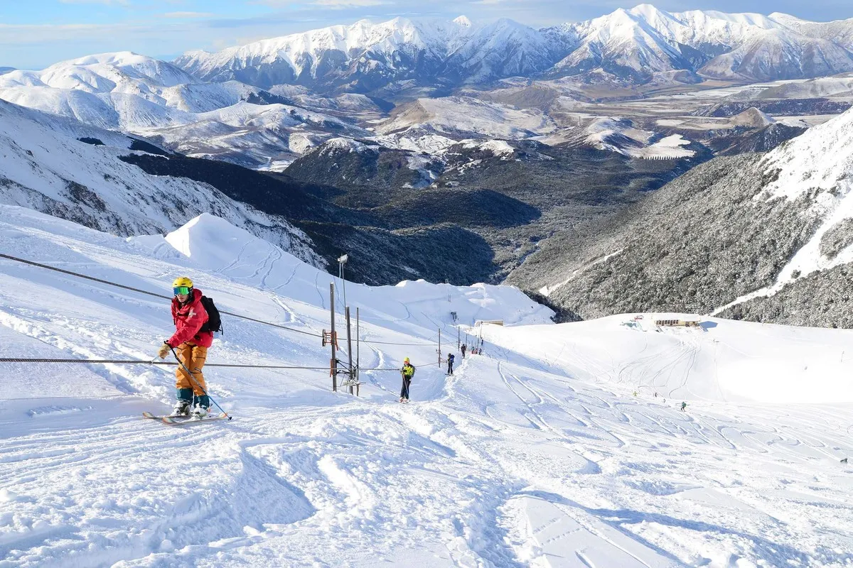 People riding the rope lift at broken river