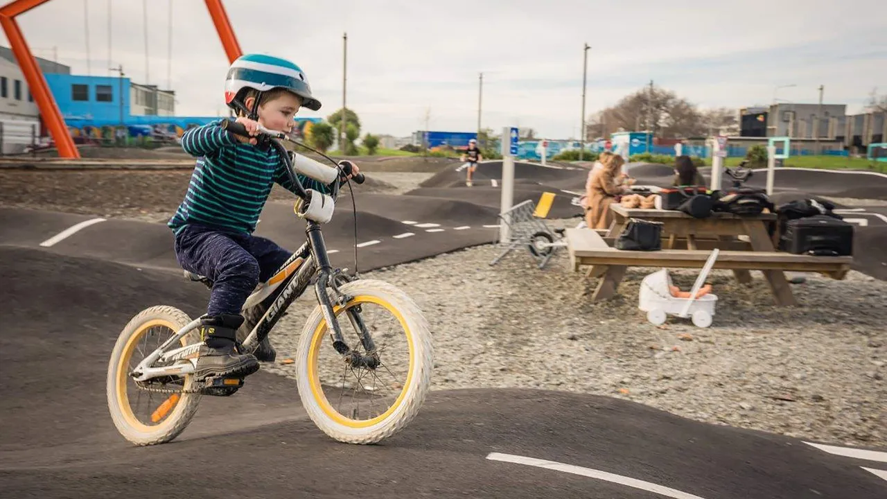 Boy riding bike on Detour pump track in Rauora Park