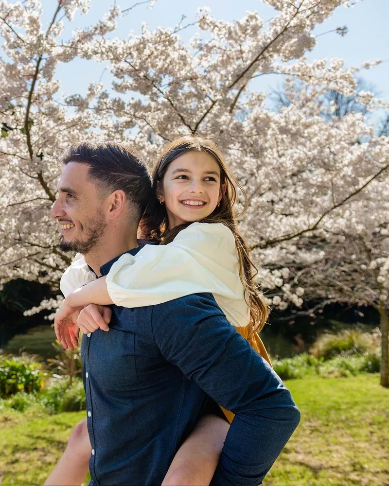Father and daughter looking at the Cherry Blossoms at the Christchurch Botanic Gardens