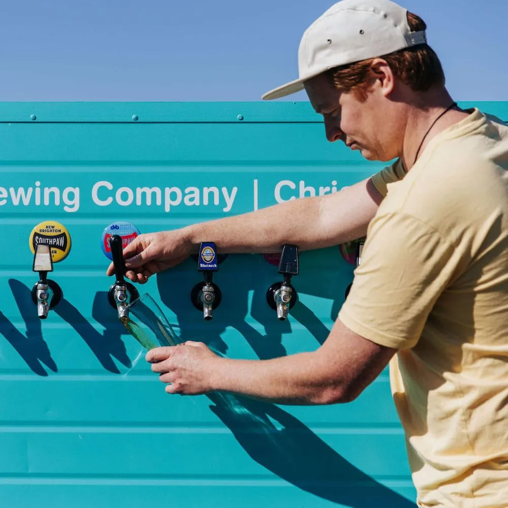 Southpaw Brewing Company, man filling cup from taps
