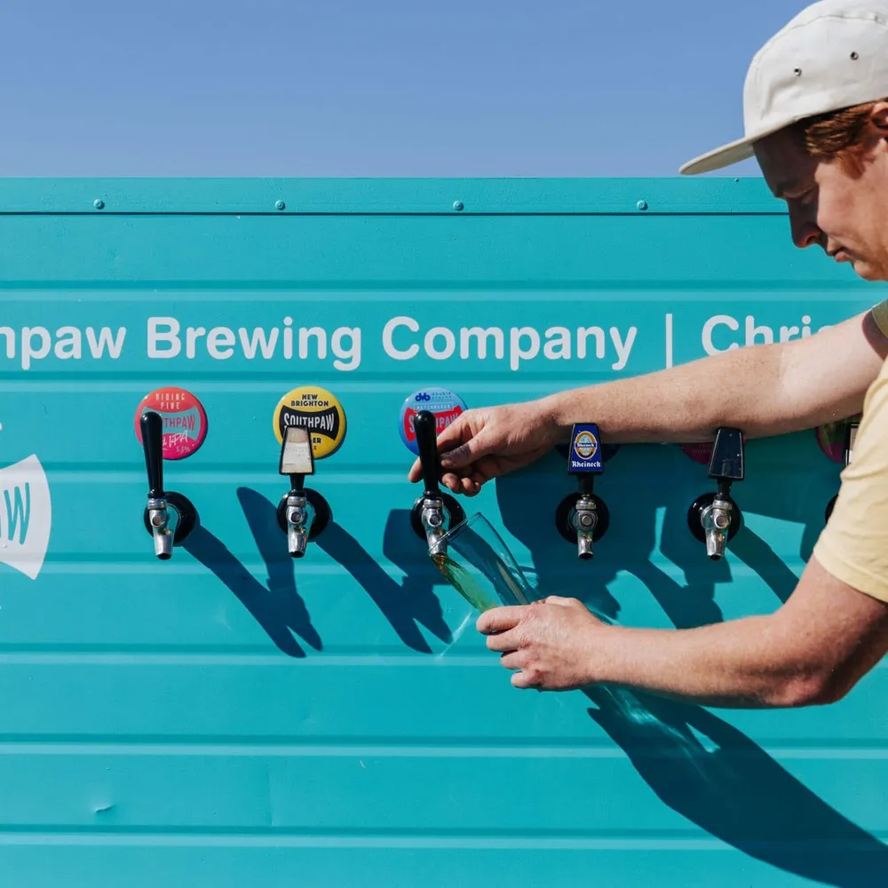 Southpaw Brewing Company, man filling cup from taps