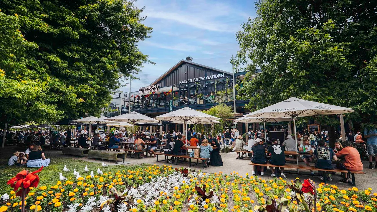 Diners sitting at tables outside Riverside Market