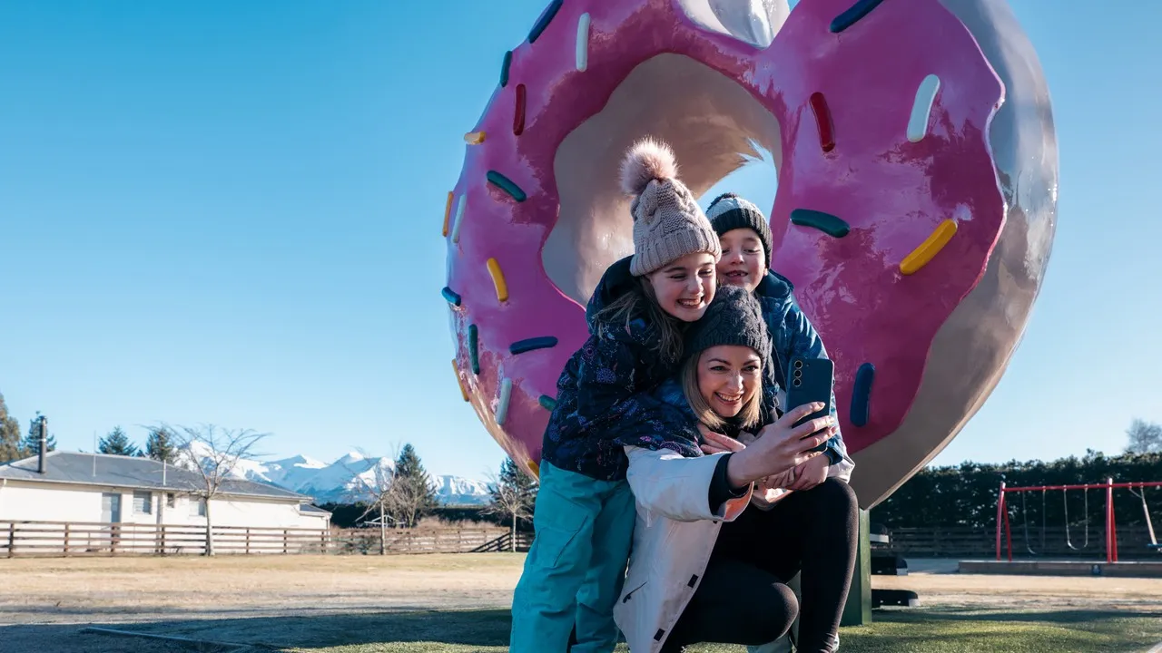 Family in front of giant donut in Springfield.
