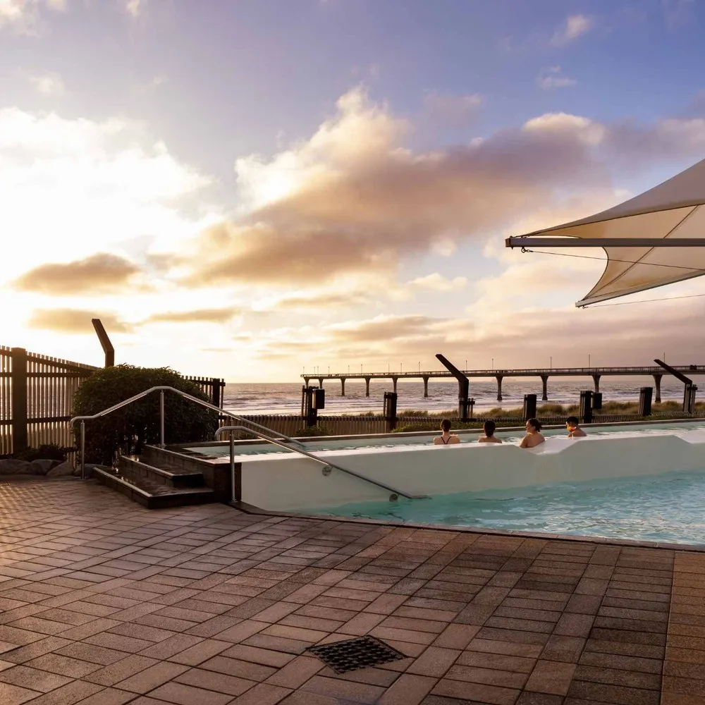 Conference delegates watching the sun rise at the hot pools in New Brighton Christchurch