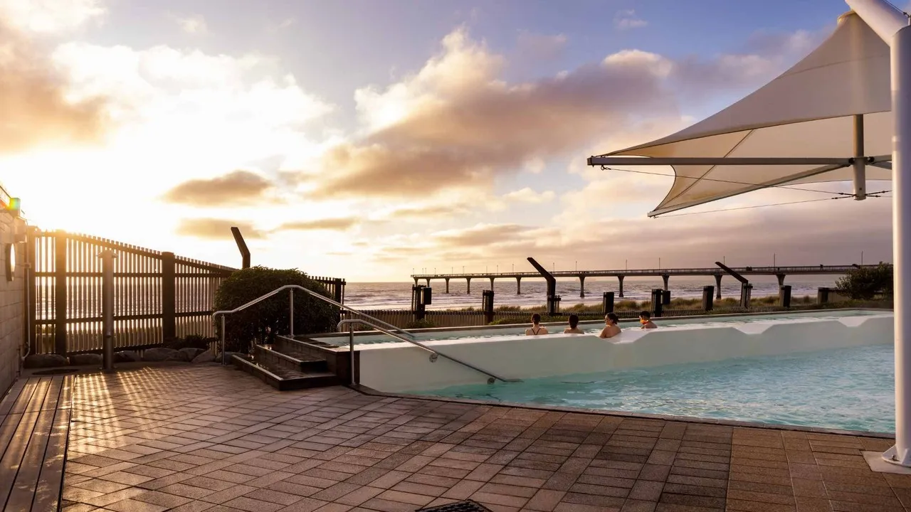 Conference delegates watching the sun rise at the hot pools in New Brighton Christchurch