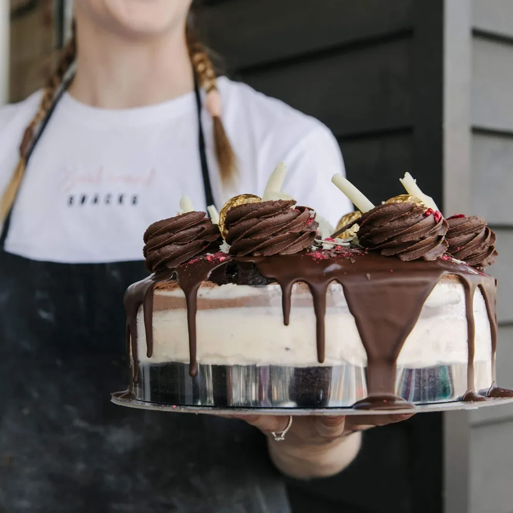 Lady holding a cheesecake at Glamour Cake