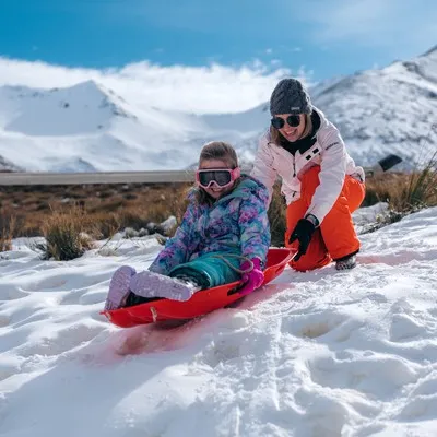 Mother and child Tobogganing in Selwyn.