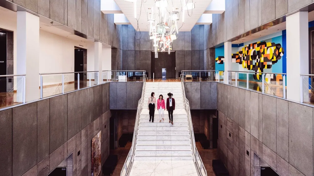 Group walking down the stairs at the art gallery.