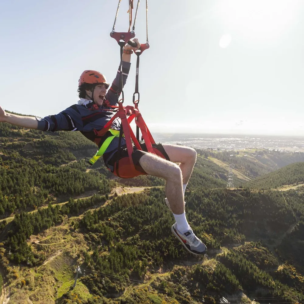 Ziplining at the Chistchurch Adventure Park with the city in the background.