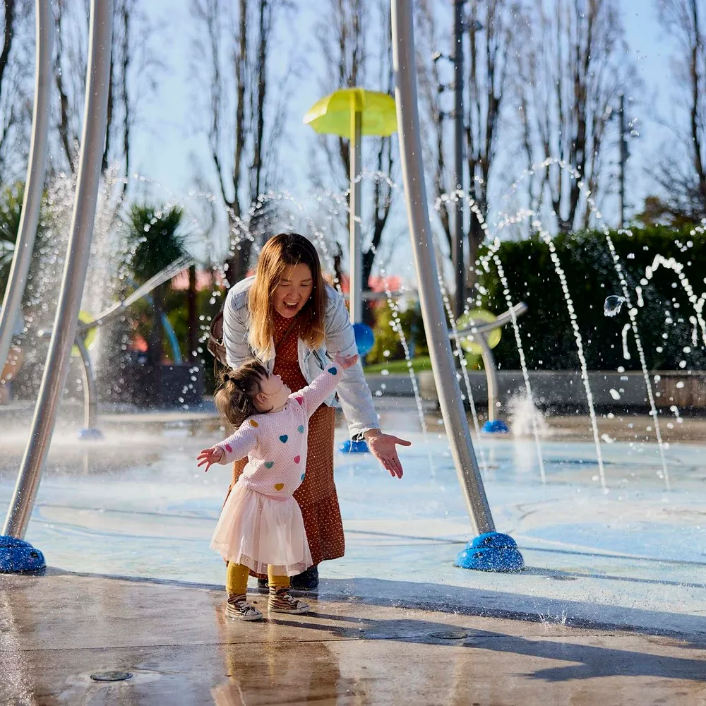 Mother and daughter playing in water at Margaret Mahy