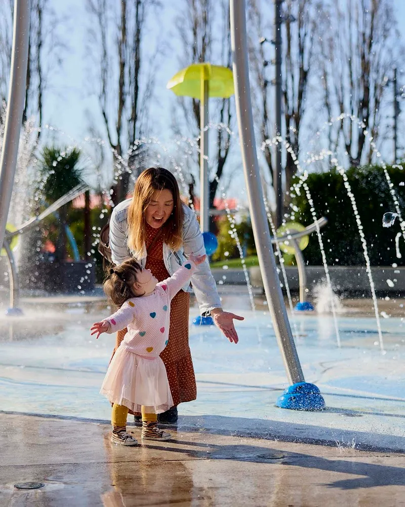 Mother and daughter playing in water at Margaret Mahy