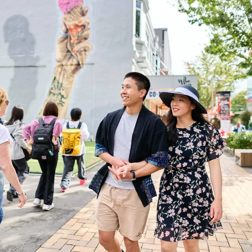 A couple enjoying a stroll down city mall Cashel Street Christchurch.