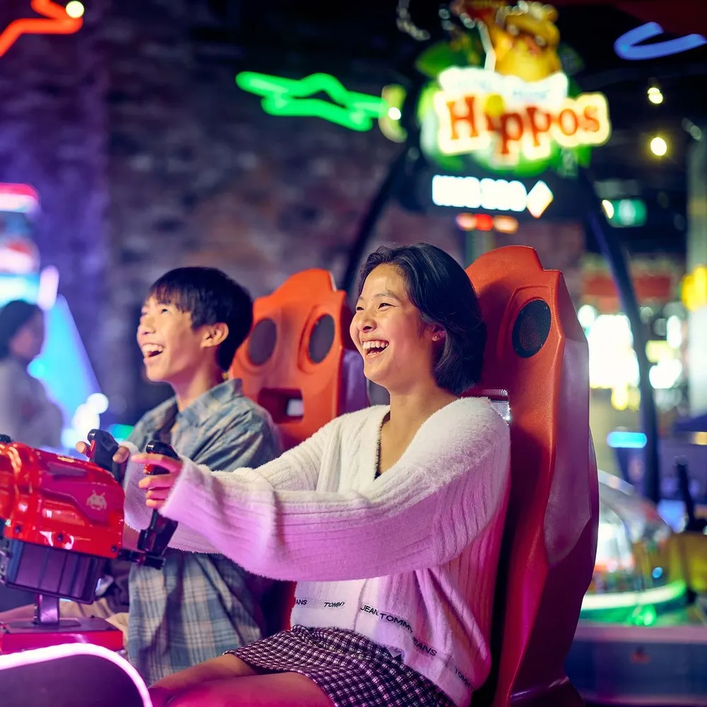 Teens enjoying arcade games at Archie Brothers.