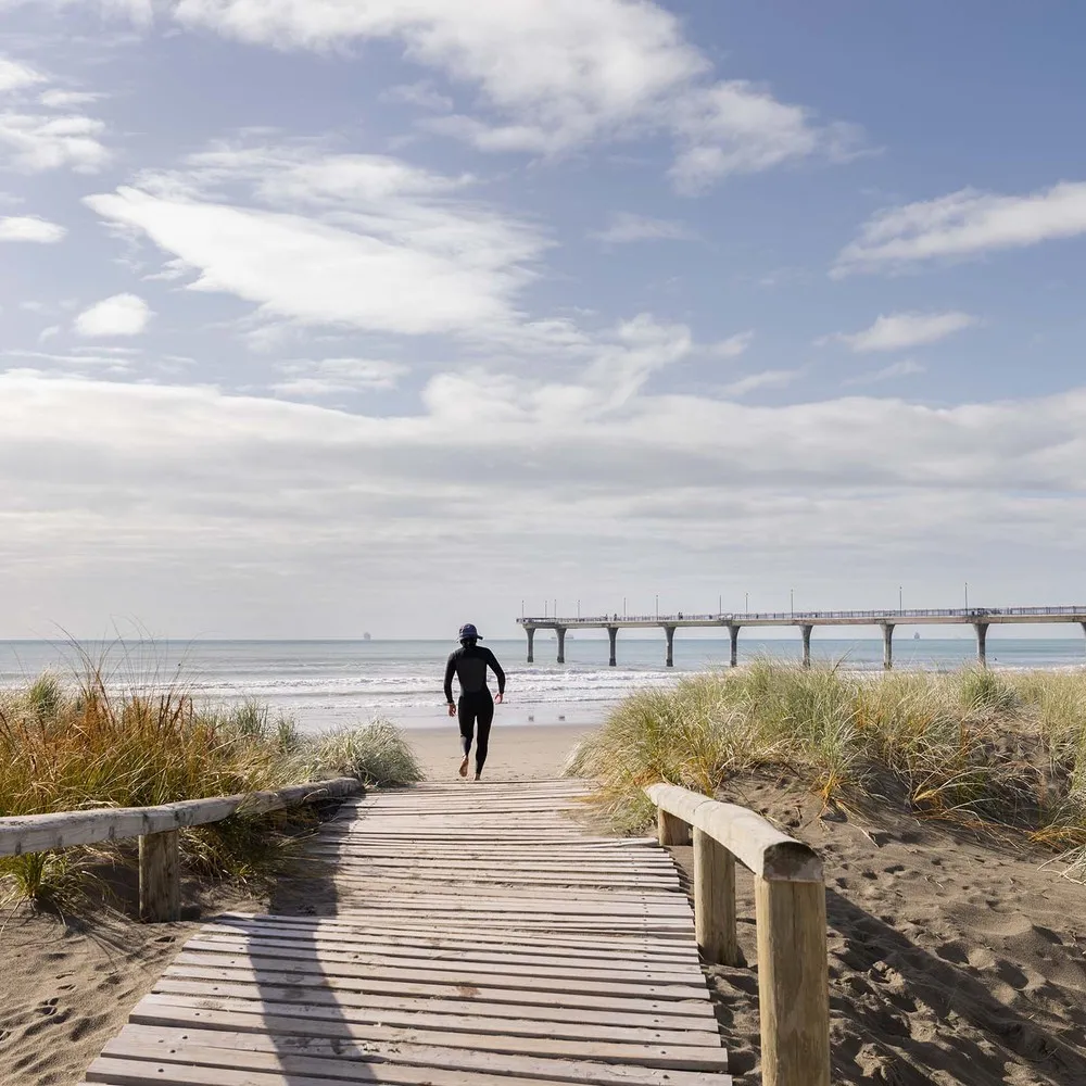 Man on boardwalk to New Brighton Beach.
