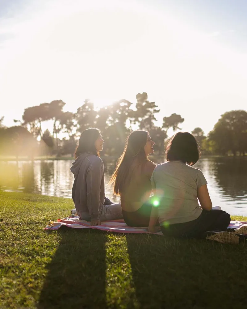 Three ladies relaxing in Hagley Park
