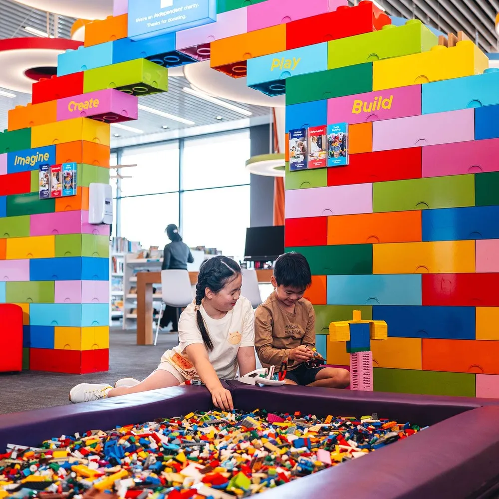 Children playing with lego at the Imagination Station at Tūranga.