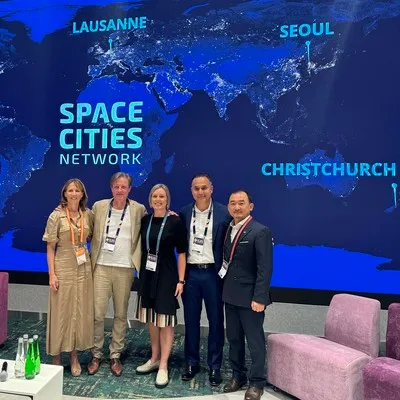 Representatives of the four space cities standing next to eachother