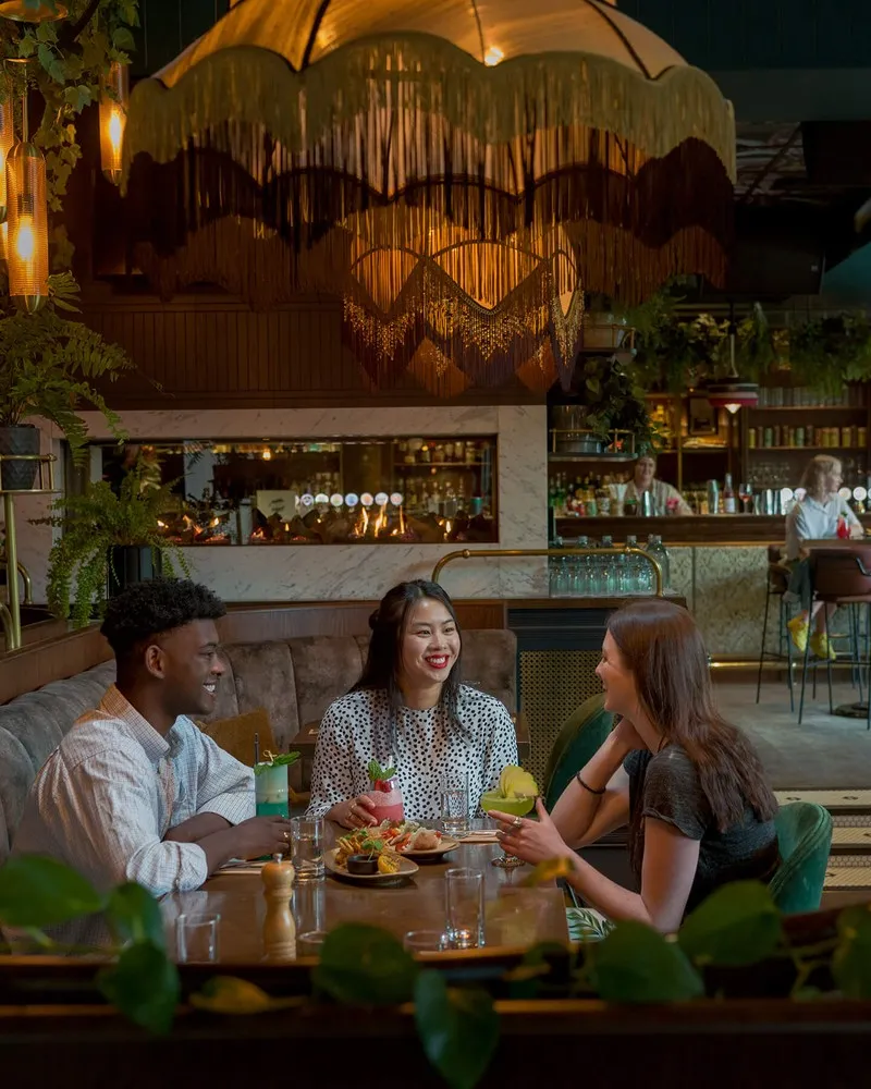 Friends enjoying drinks and food along the Terrace.