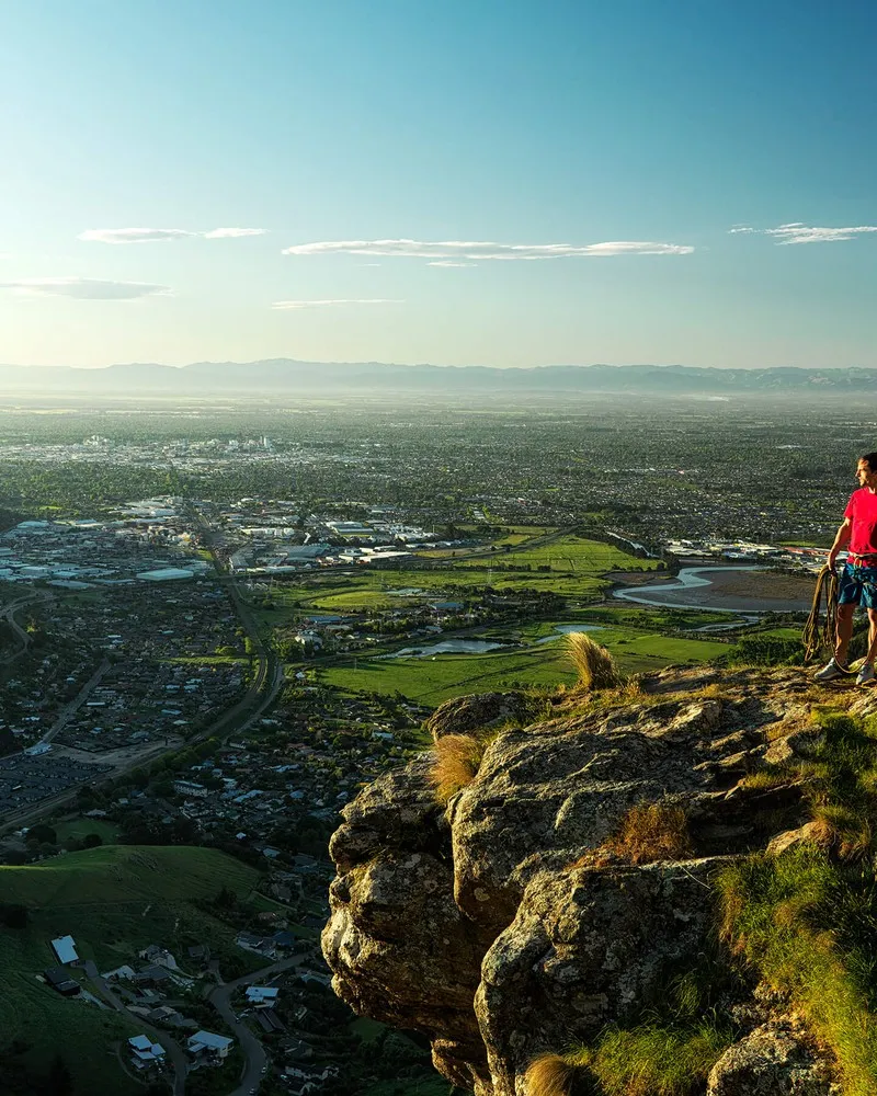 Two climbers on the Port Hills looking out over the city.