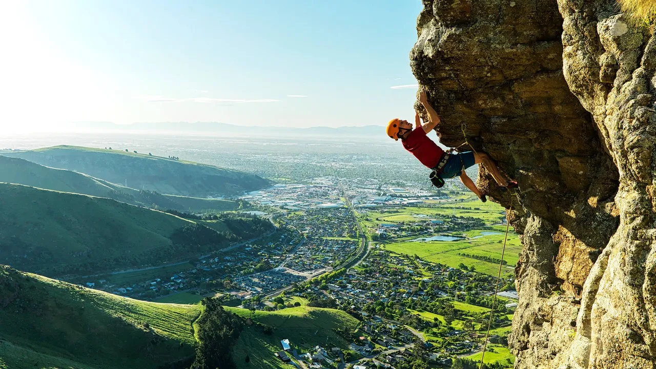 Climber on a rock in the Port Hills.