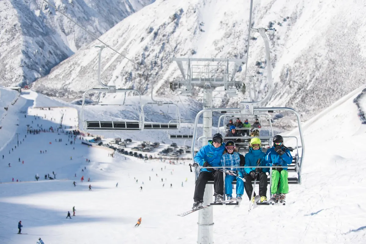 Family sitting on lift at porters