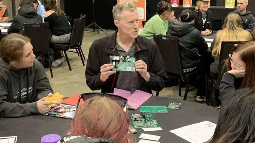 Brian Cox speaking to a group of students