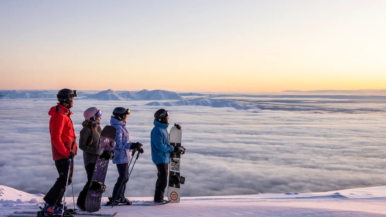Skiers and snowboarders taking in the view at Mt Hutt