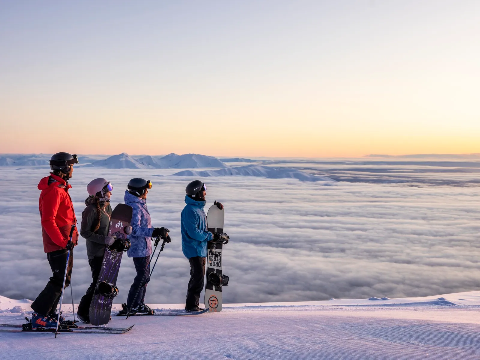 Skiers and snowboarders taking in the view at Mt Hutt