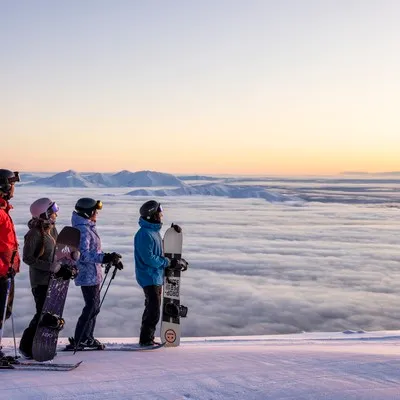 Skiers and snowboarders taking in the view at Mt Hutt