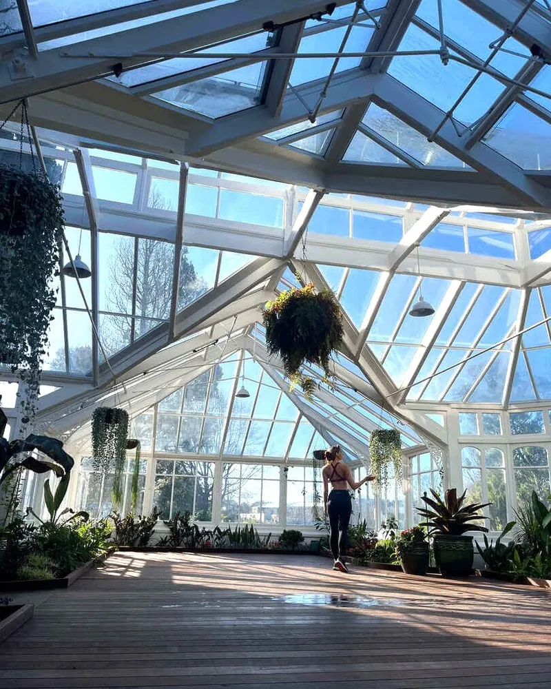 Influencer, Laura Waddell exploring the glasshouse at Mona Vale