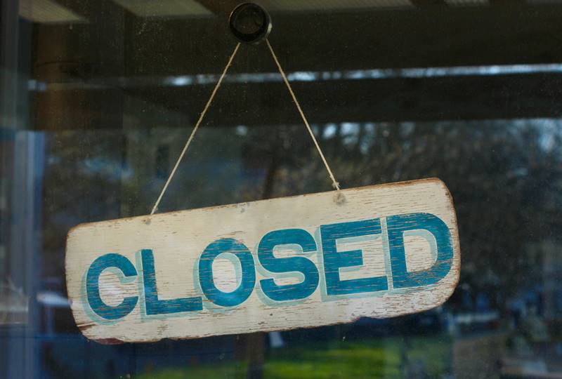 Closed sign hanging on a door