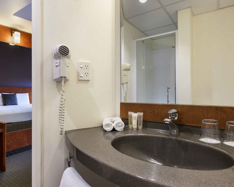 Ibis Bathroom image, showing sink with amenities and wall mounted hairdryer 