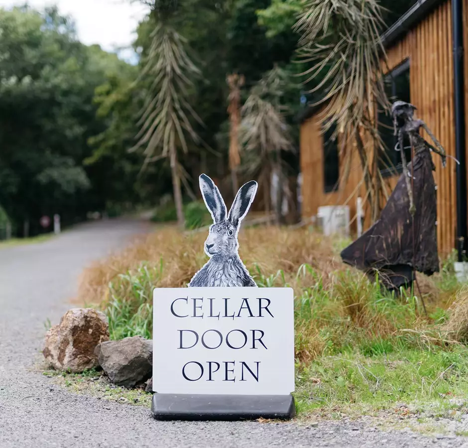 Cellar door open sign of a hare saying cellar door is open at Cross Hares Winery.