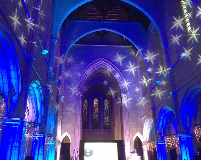 Collective Concepts Product Launch, blue patterned up lights  create a special effect across the walls of a historic church 
