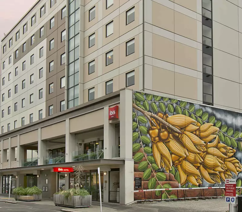 Ibis Exterior image showing the wall mural of a kowhai tree and wax eye bird