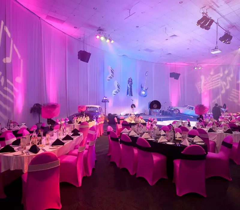 Evening Function rock n roll theme. Music notes are projected onto the walls. The stage backdrop includes records and a car